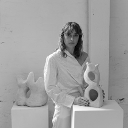 Emma Lindegaard, ceramic artist in her studio with white ceramics
