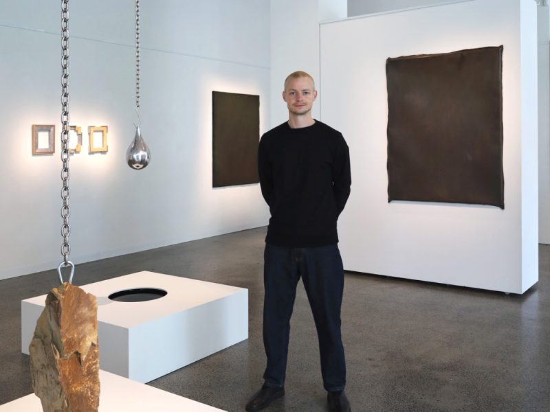 Morgan Stokes with his exhibition, Skeleton